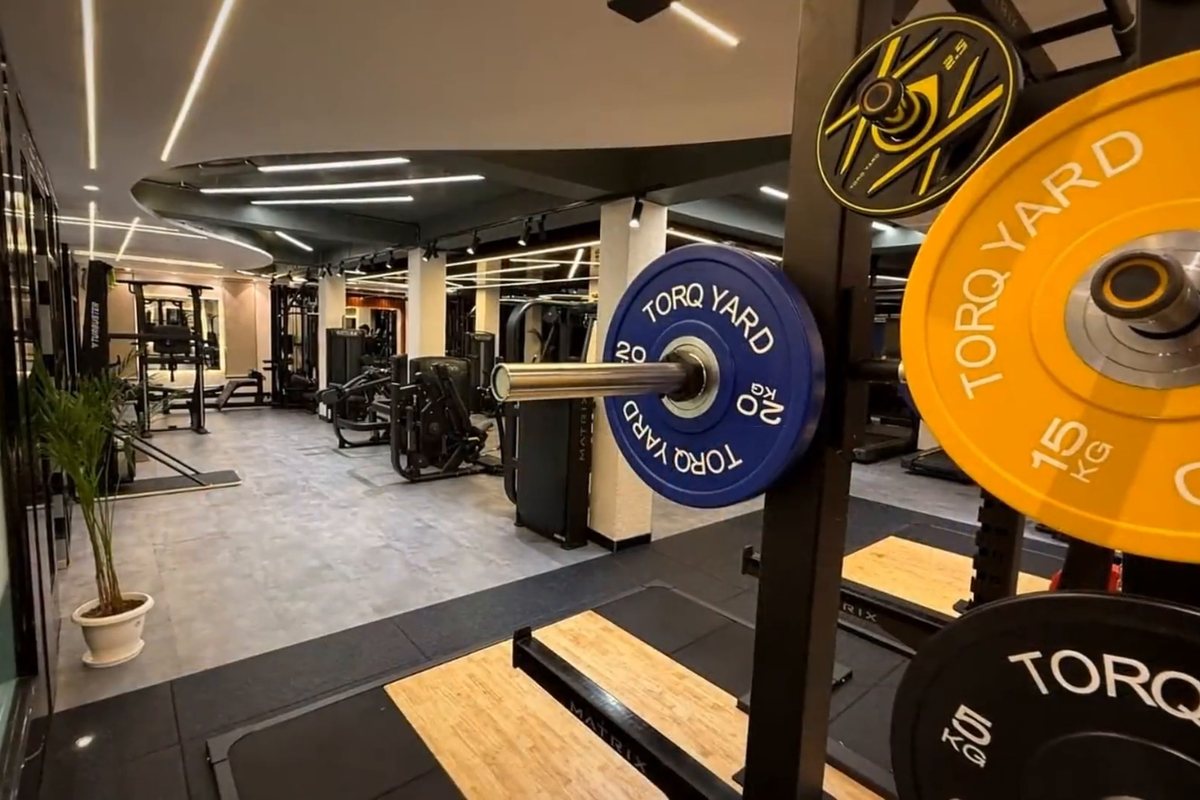 TORQ YARD branded bumper plates on the gym floor